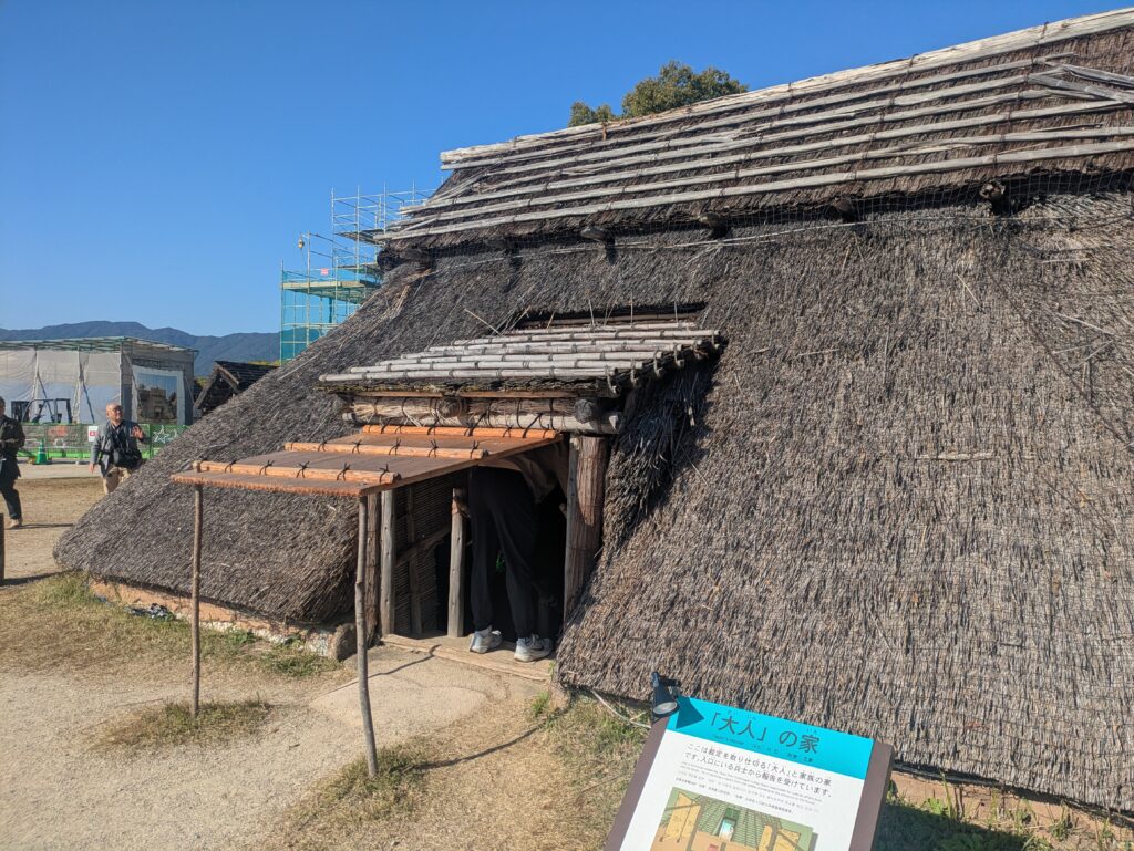 Reconstructed thatched-roof pit dwelling with detailed wood and rope construction in the South Inner Enclosure.