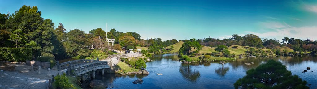 A panoramic view of the elegant arched bridge in Suizenji Jojuen Garden.