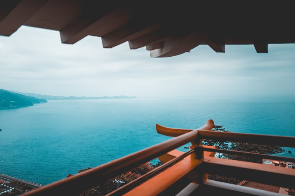 View of Atami's coastline from a pagoda, capturing the tranquil blue sea and distant mountains.