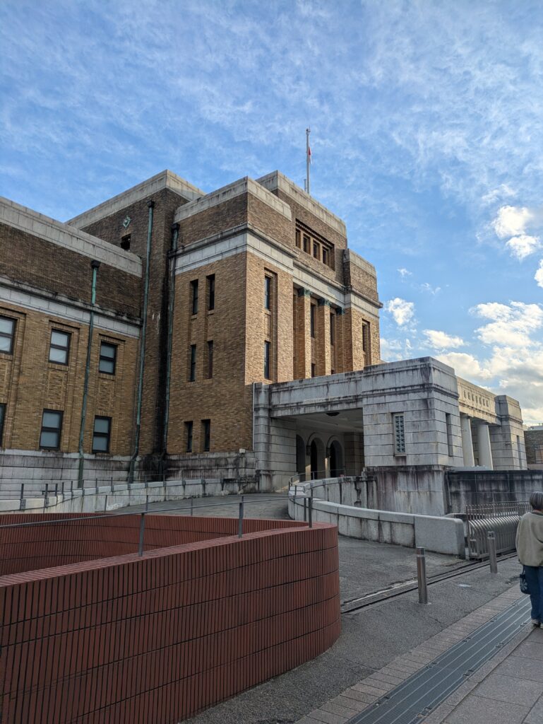 The exterior of the National Museum of Nature and Science in Ueno Park, showing its classical stone architecture against a blue sky.