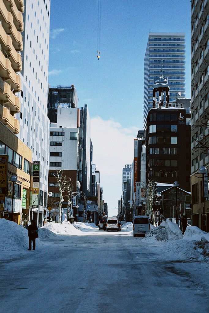 A snowy street in Sapporo, Japan, capturing urban architecture on a clear winter day.