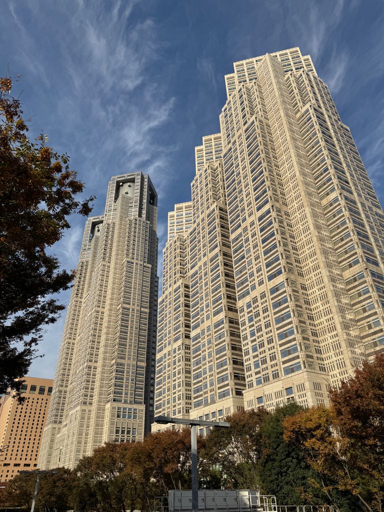 Tokyo Metropolitan Government Building towers against a clear blue sky.